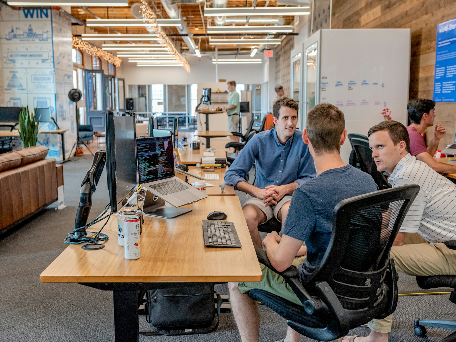 Digital agency team collaborating around a laptop